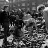 [Crowd inspecting secondhand clothes and shoes at Cumberland Street Market, Dublin]
