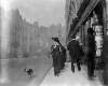 [Woman walking with dog on leash past Sibley & Co., stationers, Grafton Street]