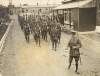[British soldiers marching out of a barracks]