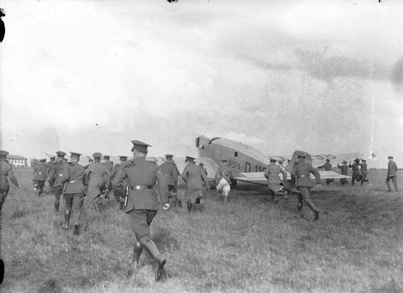 [Atlantic flyers, Baldonnell. Members of Irish Air Corps run with an airplane taking off]