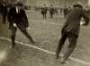 [Michael Collins and Harry Boland playing hurling on the pitch at Croke Park, on the day of the Leinster Hurling Final]