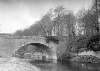 [View of a river and single arched bridge in an unidentified location]
