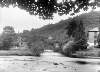 [View of a river, a single arched bridge and houses in an unidentified location]