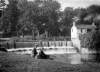 [Couple seated by a weir : location unknown]