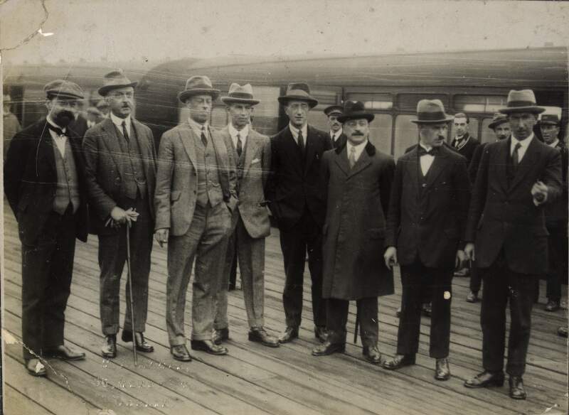 [Peace delegates arriving from London: from left to right, George Gavan Duffy, Robert Childers Barton, Erskine Childers, Desmond Fitzgerald, Arthur Griffith, Éamonn Duggan and Fionán Lynch]