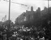 [1906. Carriage passing crowd on street decorated with flags and bunting, similar images to Clonbrock 545.]