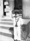 [Marcus, saluting 1902. Little boy wearing sailor suit and wide straw hat. Porch of Clonbrock in background.]