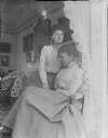 [A.T.Katie and E. Dillon 1902. Elderly woman seated in drawing room, younger woman wearing floral blouse seated beside, Edith (b.1878) with her Aunt Katie Dillon. Drawing Room of Clonbrock House.]
