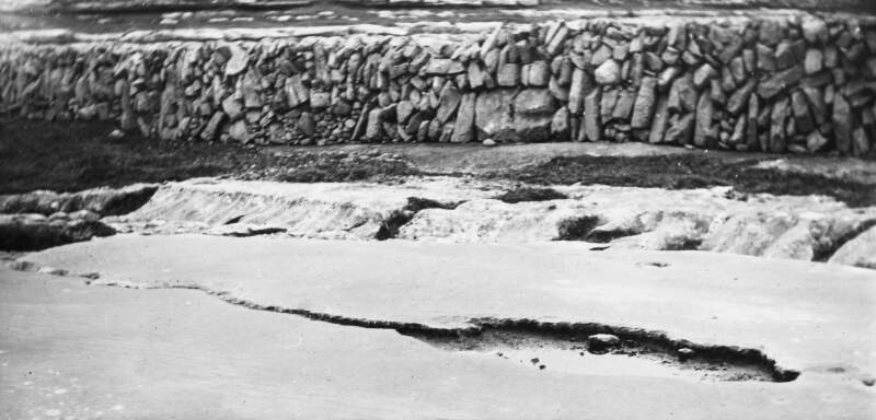 Stone wall at shoreline - indicative of erosion of sea bed.
