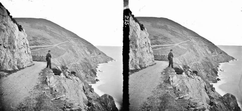 Bray Head, high angle, railway-line round cliffs (man in foreground), Bray, Co. Wicklow