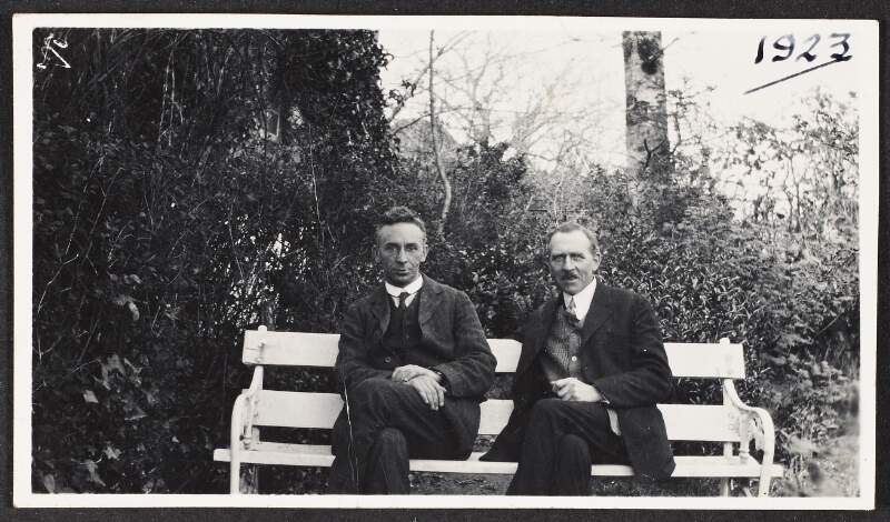 Photograph of Diarmuid Lynch and an unidentified man seated on a bench,