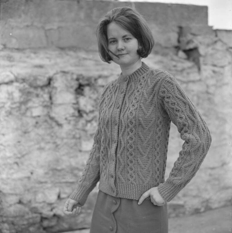 [Female modelling garments for Dungloe Co-op knitting, Co. Donegal]