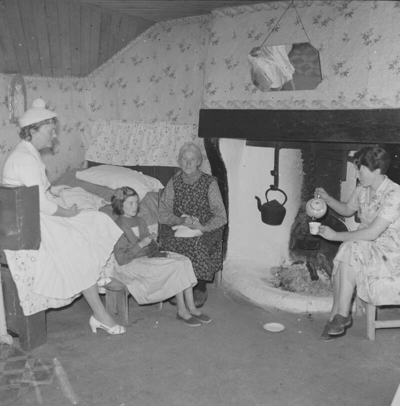 [Women sitting by fire in house, Lettermacaward, Co. Donegal]