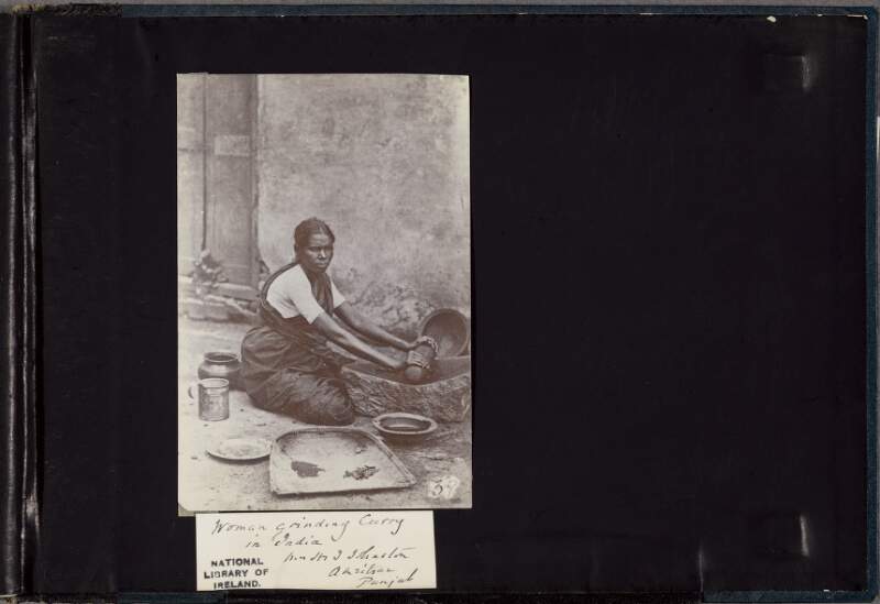 Woman grinding curry in India
