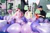 Close up of activists standing on float amid pink balloons. St Patrick's Day Parade; National Lesbian and Gay Federation Float