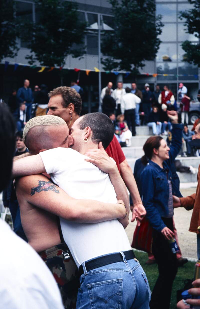 Close up of crowd dancing featuring male couple kissing during the after party at the Civic Offices Amphitheatre on Wood Quay. Dublin Lesbian and Gay Pride March