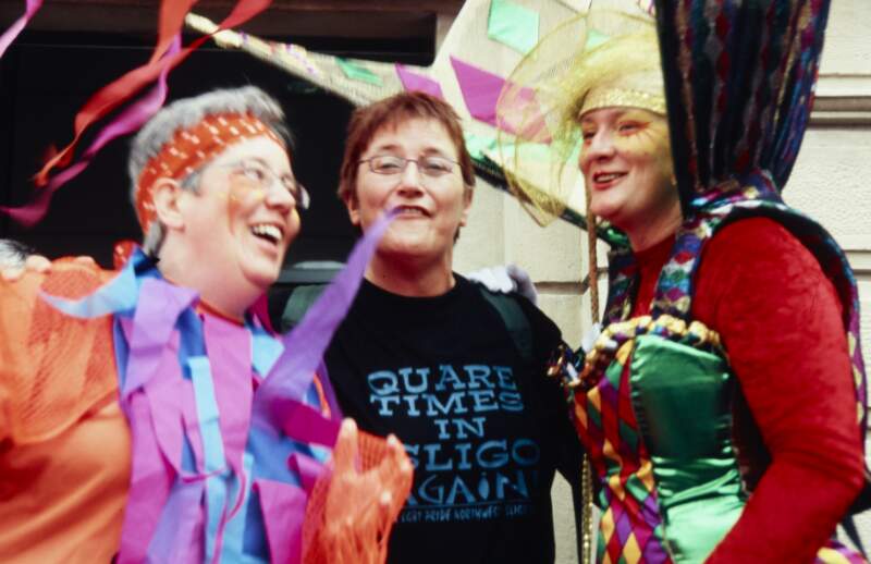 Two women in colourful costumes with Joni Crone Sligo Lesbian Gay Bisexual and Transgendered Pride